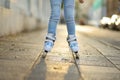 Young girl learning to roller skate on beautiful summer day on a street Royalty Free Stock Photo