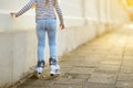 Young girl learning to roller skate on beautiful summer day on a street Royalty Free Stock Photo