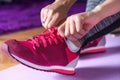 Ready to Move: Young Female Legs with Red Sneakers on Purple Fitness Mat Royalty Free Stock Photo