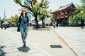 Young girl lens man walking outside the temple