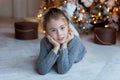 Young girl lies near a Christmas tree Royalty Free Stock Photo