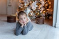 Young girl lies near a Christmas tree Royalty Free Stock Photo