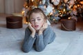 Young girl lies near a Christmas tree Royalty Free Stock Photo