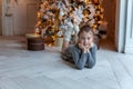 Young girl lies near a Christmas tree Royalty Free Stock Photo