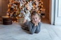 Young girl lies near a Christmas tree Royalty Free Stock Photo