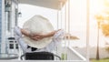 Young girl lifestyle wearing summer hat on sunny day relaxing taking it easy happily sitting on porch at beach-house on beach Royalty Free Stock Photo