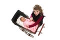 Young girl lifting doll from antique baby carriage Royalty Free Stock Photo