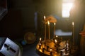 A young girl lighting a candle in a church in the name of the health of loved ones, the front and background are blurred with a Royalty Free Stock Photo