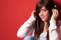 Young girl listening music with headphones on red Royalty Free Stock Photo