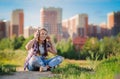 Young girl listening to music on headphones, urban street style, outdoor street style hipster dj woman in black cap and