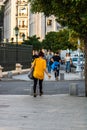 Young girl listening music while walking with a coffee cup in her hand in Bucharest, Romania, 2019