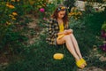 A young girl with long blond hair knits a yellow sweater in the garden in the summer. woman makes clothes with hands closeup Royalty Free Stock Photo
