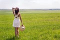 Young girl with long dark hair standing on a green field Royalty Free Stock Photo