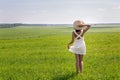 Young girl with long dark hair standing on a green field Royalty Free Stock Photo