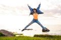 Girl jumping at sunset against the background of the sea Royalty Free Stock Photo