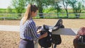 young girl with long hair and plaid, shirt with two saddles on the fence one saddle prepares Royalty Free Stock Photo