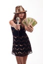 Young girl with long hair wearing a black dress and gold hat with a microphone in his hand and money on a white background Royalty Free Stock Photo