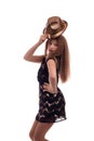 Young girl with long hair wearing a black dress and gold hat on a white background Royalty Free Stock Photo