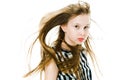 Young girl with long straight hairs blown by wind in studio Royalty Free Stock Photo