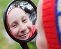 The young girl look in funhouse mirror Royalty Free Stock Photo