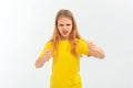 young girl looking at the camera with negative facial expression raising fists furiously, isolated on white background, wearing in Royalty Free Stock Photo