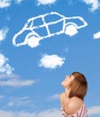 Young girl looking at car cloud on a blue sky Royalty Free Stock Photo