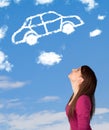 Young girl looking at car cloud on a blue sky Royalty Free Stock Photo
