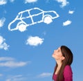 Young girl looking at car cloud on a blue sky Royalty Free Stock Photo
