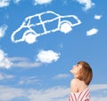 Young girl looking at car cloud on a blue sky Royalty Free Stock Photo