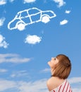 Young girl looking at car cloud on a blue sky Royalty Free Stock Photo