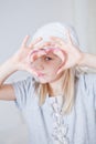 Young girl looking through gingerbread biscuit cutter