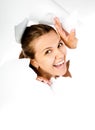 Young girl looking through hole in paper Royalty Free Stock Photo