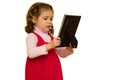 Young girl looking sadly at picture frame