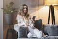 Young girl looking on screen of her smartphone. Female texting and sending messages on mobile phone. Entertainment apps and