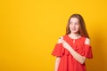 Young girl looking sideways and pointing her index finger at copy space your text or promotional content. Banner Royalty Free Stock Photo