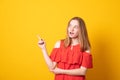Young girl looking sideways and pointing her index finger at copy space your text or promotional content Royalty Free Stock Photo