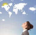 Young girl looking at world clouds and sun on blue sky Royalty Free Stock Photo