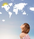 Young girl looking at world clouds and sun on blue sky Royalty Free Stock Photo