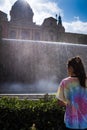 A young girl looks fascinated for the spectacular effects of the water in the National Palace`s fountain at Barcelona Spain