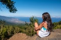 Young girl looks at the landscape with her dog Royalty Free Stock Photo