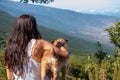 Young girl looks at the landscape with her dog Royalty Free Stock Photo