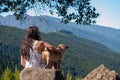 Young girl looks at the landscape with her dog Royalty Free Stock Photo