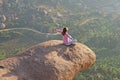 A young girl in a lotus pose is greeting the sun on a background