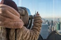 Young Girl Lurking Through Tourist Binoculars Reflecting New York City.Young girl peeking through tourist binoculars with reflecti Royalty Free Stock Photo