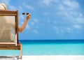 Young girl lying on a beach lounger with glasses in hand