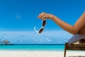 Young girl lying on a beach lounger with glasses in hand Royalty Free Stock Photo