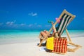 Young girl lying on a beach lounger with glasses in hand on the Royalty Free Stock Photo