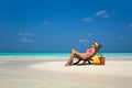 Young girl lying on a beach lounger