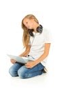 Young girl lying on the floor listening to music over white back Royalty Free Stock Photo