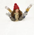 Young girl lying in the snow and laughs Royalty Free Stock Photo